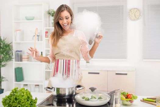 Young beautiful woman cooking healthy meal in the kitchen.