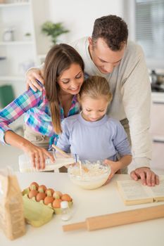 Cheerful beautiful family enjoying while preparing food in the kitchen.