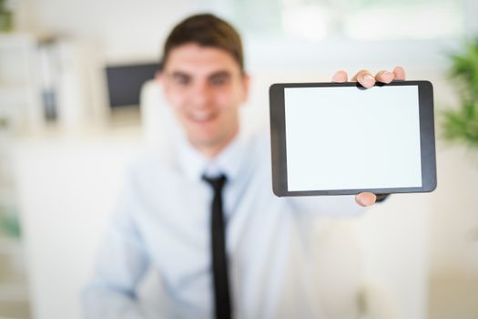 Close-up of a businessman holding digital tablet in the office. Selective focus. Focus on foreground, on tablet.