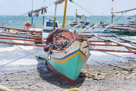 Beached fishing vessels with outriggers at General Santos City, the southernmost city of The Philippines.