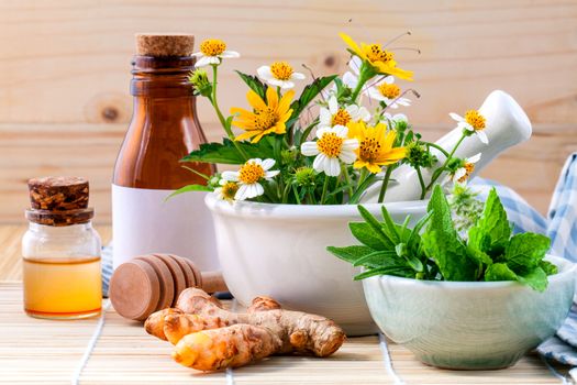 Alternative health care fresh herbal ,honey and wild flower with mortar on wooden background.