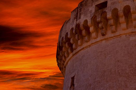 ruins of medieval old tower of castle under sunset sky in Matera Italy