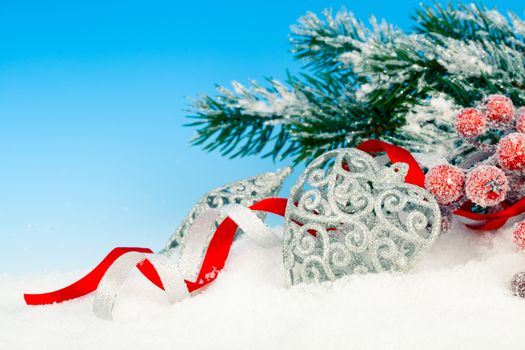 Christmas decoration over snow, blue background