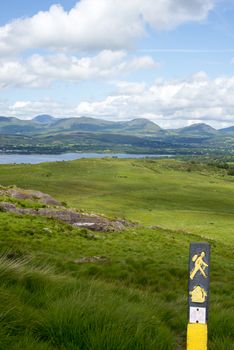 hiking signpost with mountain view from the kerry way walk in ireland