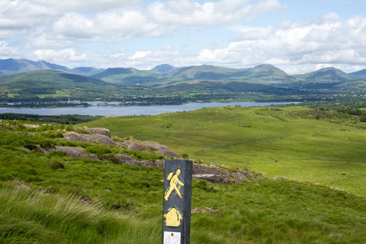 hiking signpost with mountain view from the kerry way walk in ireland