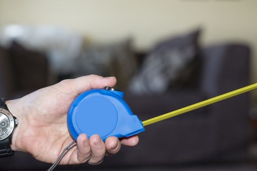 measuring tape in hand for do it yourself home improvements