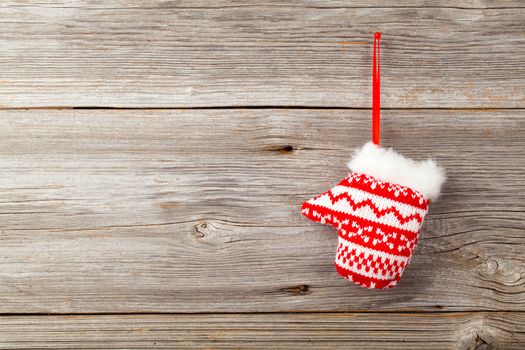 Red mitten on wooden background