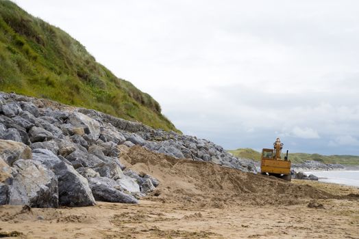mechanical excavator working on coastal protection for the ballybunion golf course in ireland