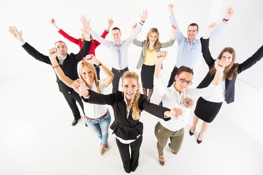 Group of a happy Business People standing together with raised arms.