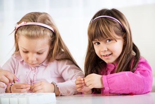 Two cute little girls playing at home 