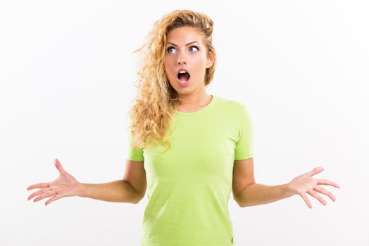Portrait of beautiful pouty young woman surprising and spreads his arms. White background.