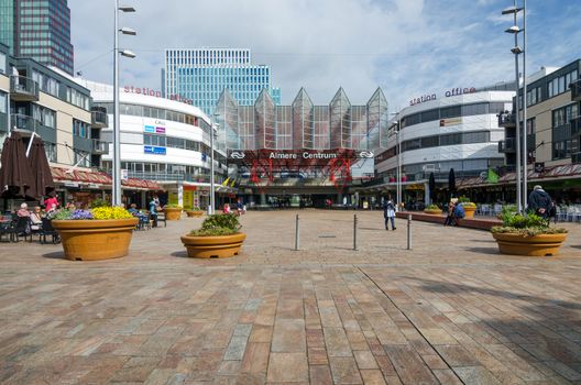 Almere, Netherlands - May 5, 2015: People visit Almere Central Station on May 5, 2015 in Almere, Netherlands. The station opened may 1987 and is designed by Peter Kilsdonk. Under the station lies a bus station