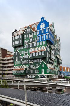 Zaandam, Netherlands - May 5, 2015: People visit Inntel Hotels on May 5, 2015 in Zaandam, Netherlands. Opened in 2009, the design attracts guests by incorporating the traditional architecture of the Zaan region.