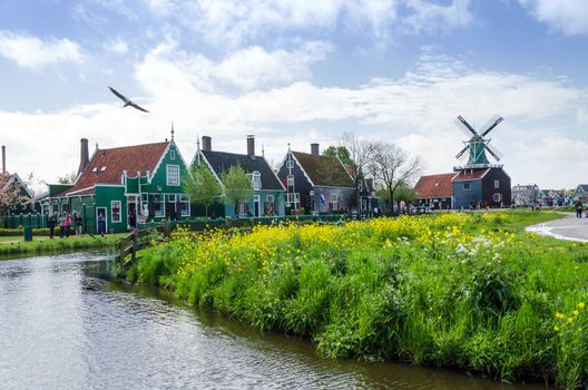 Zaanse Schans, Netherlands - May 5, 2015: Tourist visit Windmills and rural houses in Zaanse Schans, Netherlands. This village is a popular touristic destination in Netherlands