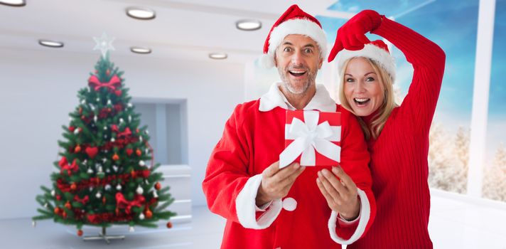 Festive couple against home with christmas tree