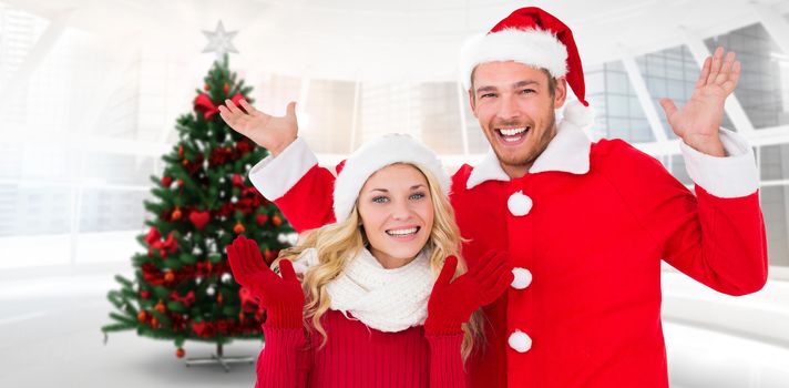 Young festive couple against home with christmas tree