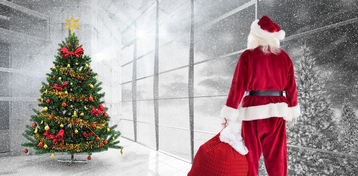 Santa carrying sack of gifts  against home with christmas tree