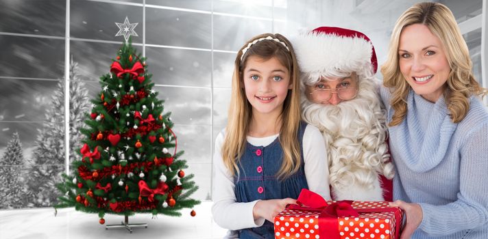 Mother and daughter with santa claus against home with christmas tree