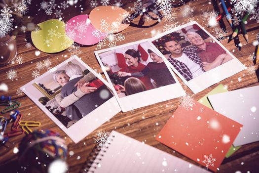 Snowflakes against high angle view of office supplies with blank instant photos