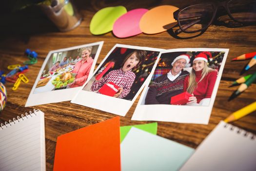 High angle view of office supplies and blank instant photos against proud mother showing roast turkey