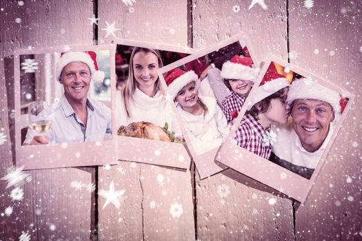 Instant photos on wooden floor against handsome man in santa hat toasting with white wine