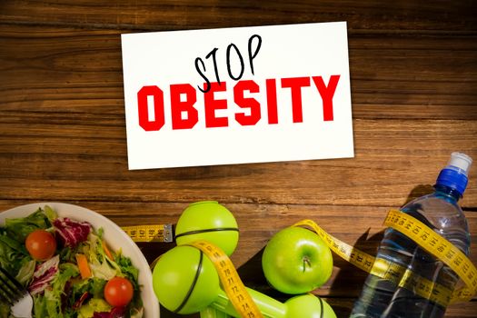 Stop obesity against indicators of healthy lifestyle on wooden table