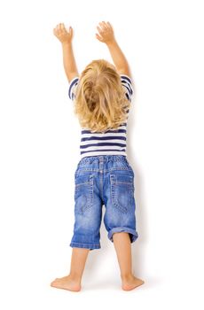 Back view of little boy with hands up on white background