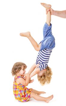 Happy little sister and brother playing together on white background