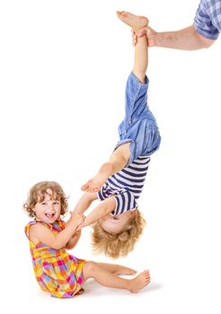 Happy little sister and brother playing together on white background