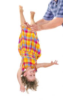 Father holding his little daughter upside down. Trust concept.