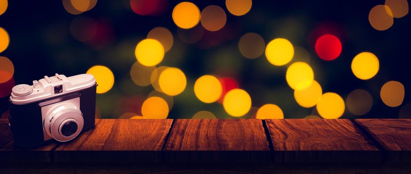 camera against desk with christmas tree in background