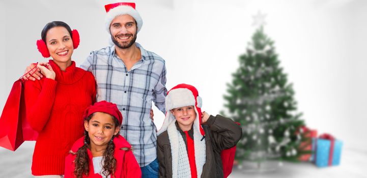 Happy family looking at camera  against home with christmas tree