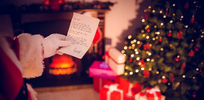 santas list against santa claus holding a paper