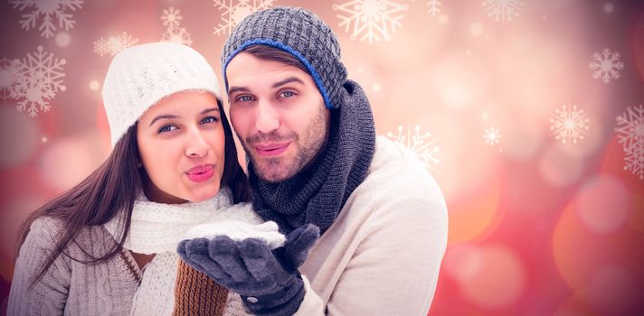 Young winter couple against glowing christmas background