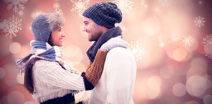 Young winter couple against glowing christmas background