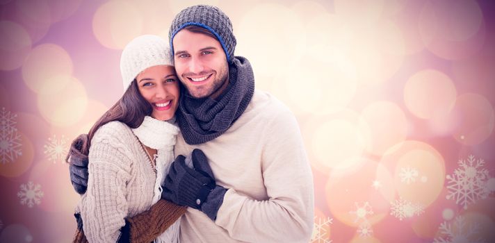 Young winter couple against glowing christmas background