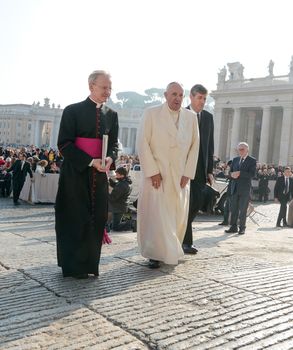 ITALY, Vatican City: Pope Francis walks through St. Peter's Square before holding his weekly general audience in Vatican City on November 11, 2015. During his address, the pope spoke on the importance of family and togetherness, telling devotees that a family who turns its attention to TVs and smartphones at dinner is hardly a family.