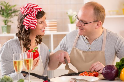 Happy couple preparing food in the kitchen