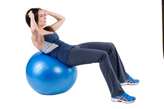Young woman shows finishing position of Abdominal Fitball Workout, isolated on white