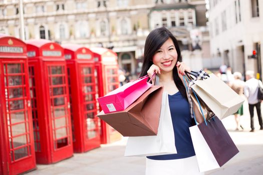 young japanese woman in london with shopping bags