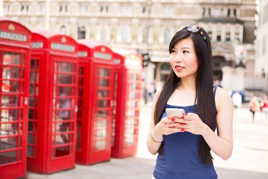 Japanese woman in London using her mobile phone