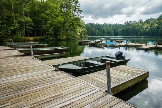 Aluminium bass fishing boat at wooden dock in Virginia, America USA