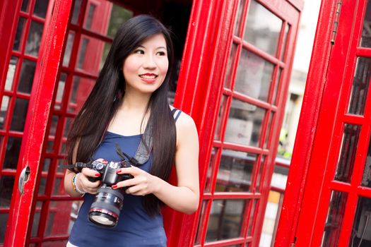 Japanese tourist in london holding her camera