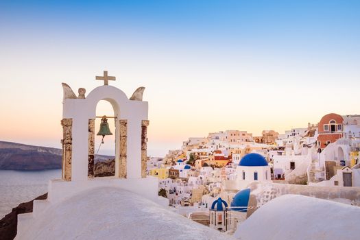 Scenic view of romantic sunset in colorful Santorini village Oia, Greece