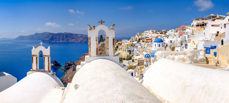 Panoramic view at rooftops of romantic village Oia in Santorini, Greece