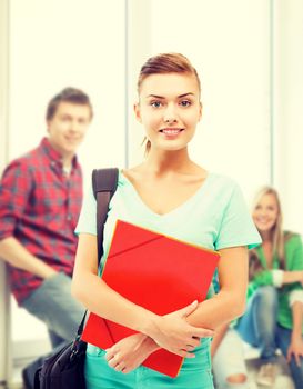 education concept - smiling student girl with folders and school bag