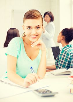 picture of student girl with notebook and calculator at school