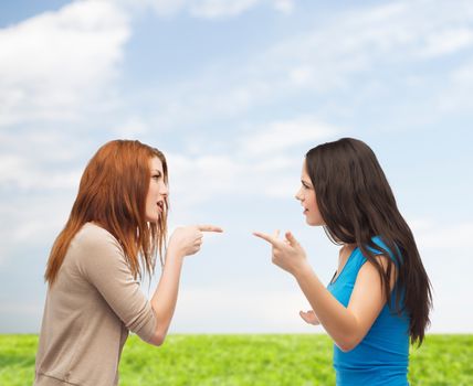 bullying, friendship and people concept - two teenagers having a fight