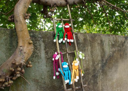 Amazing scene with group of knitted monkey climb tree, 2016 is year of the monkey, monkey symbol in colorful yarn to happy new year