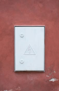 hight voltage electric board on red wall